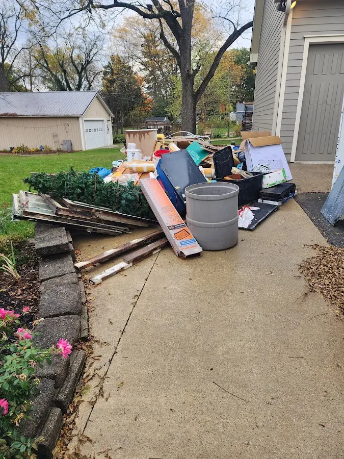 Dumpster being loaded with debris for Estate Cleanout Dumpster Rental in Great Falls
